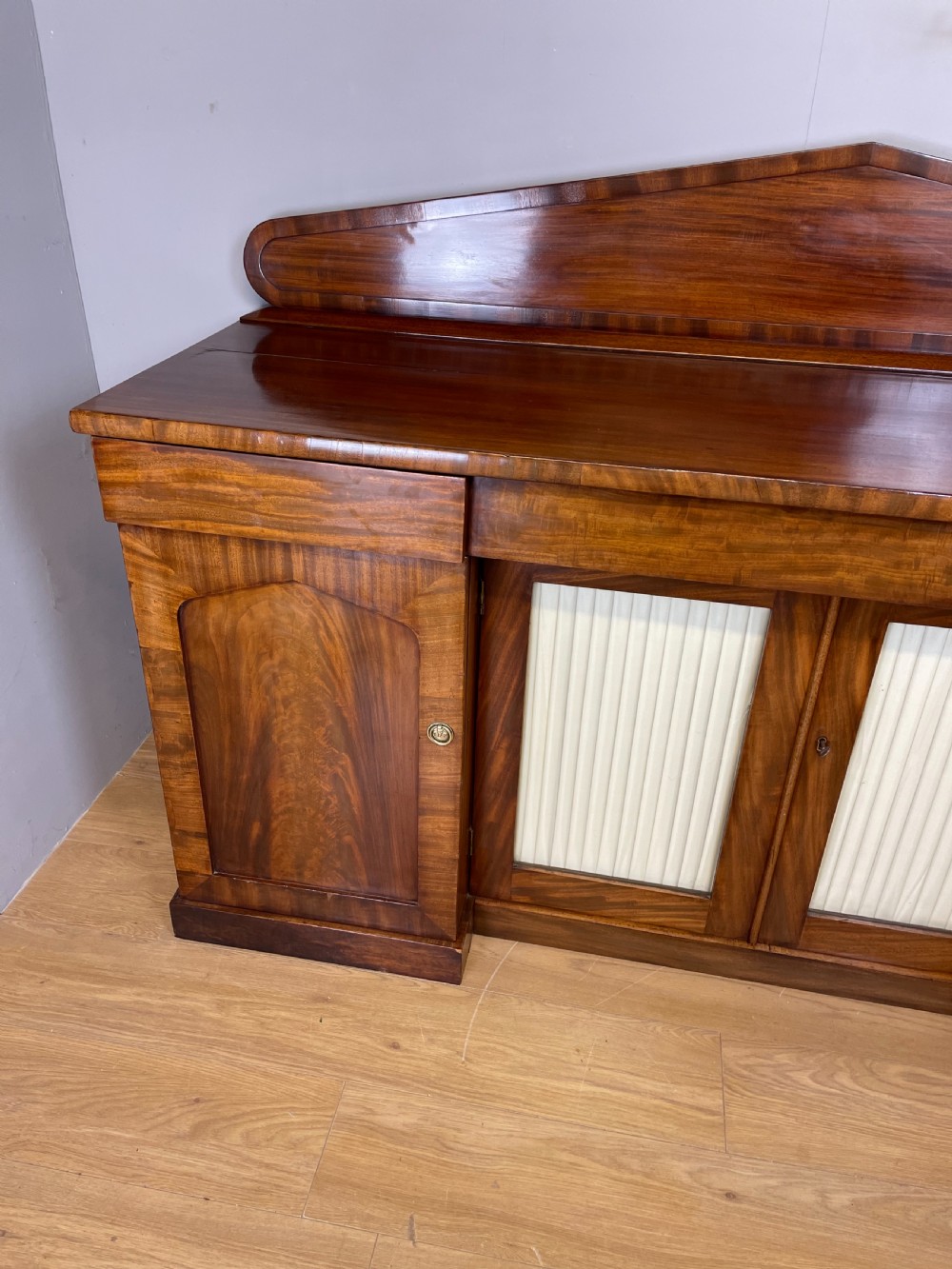 Late Georgian flame mahogany four door sideboard  View III