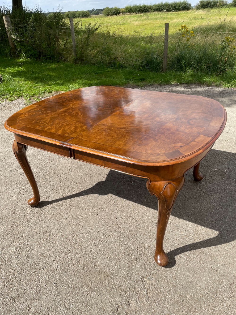 Burr walnut extending dining table by Maple and Co  View XIII