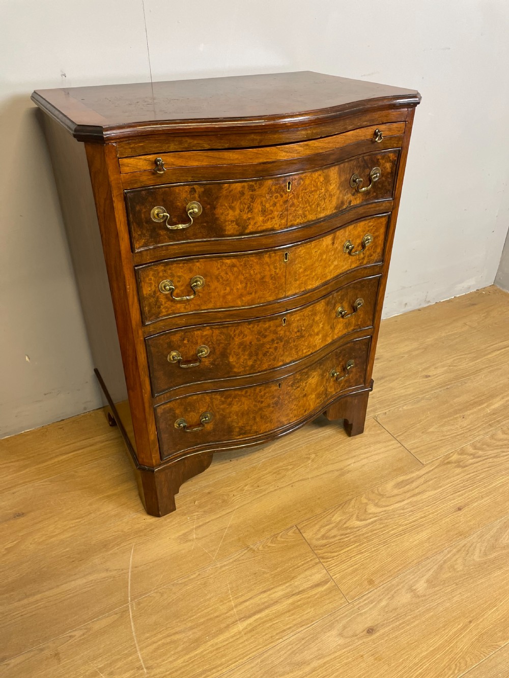 Small serpentine fronted burr walnut chest of drawers 