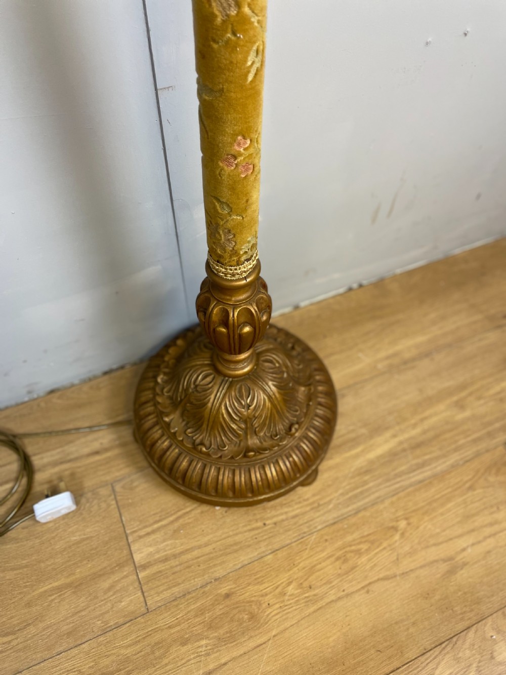An Italian carved giltwood standard lamp with floral fabric central column details and a leaf-carved circular base. View IV