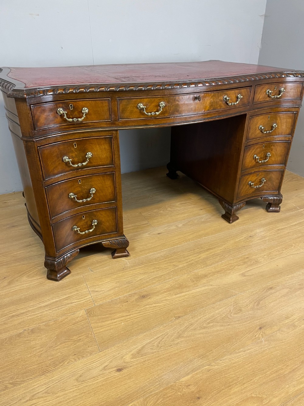 Serpentine sided Chippendale style mahogany desk with inset leather top View II