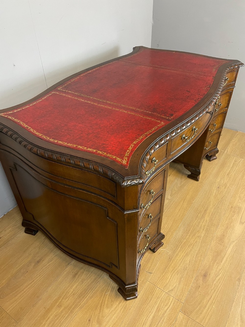 Serpentine sided Chippendale style mahogany desk with inset leather top View IV