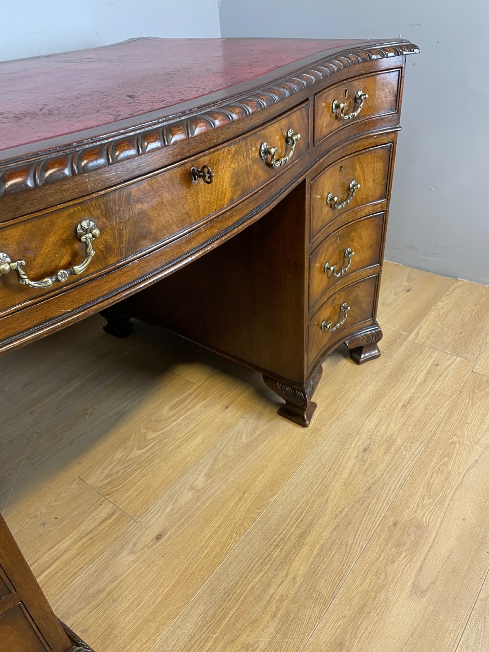 Serpentine sided Chippendale style mahogany desk with inset leather top View VI
