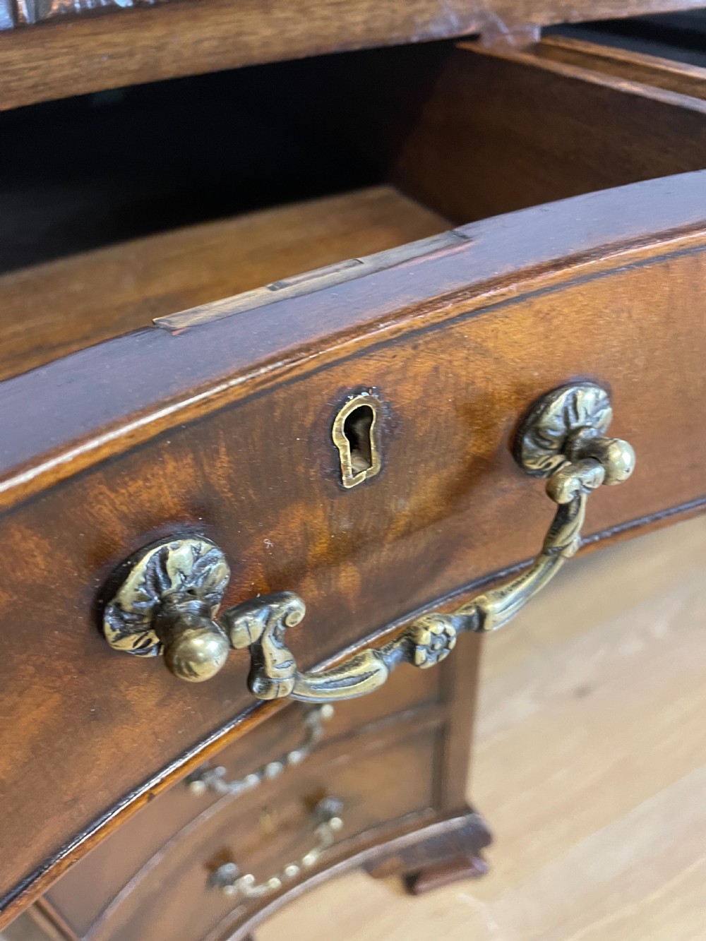 Serpentine sided Chippendale style mahogany desk with inset leather top View IX