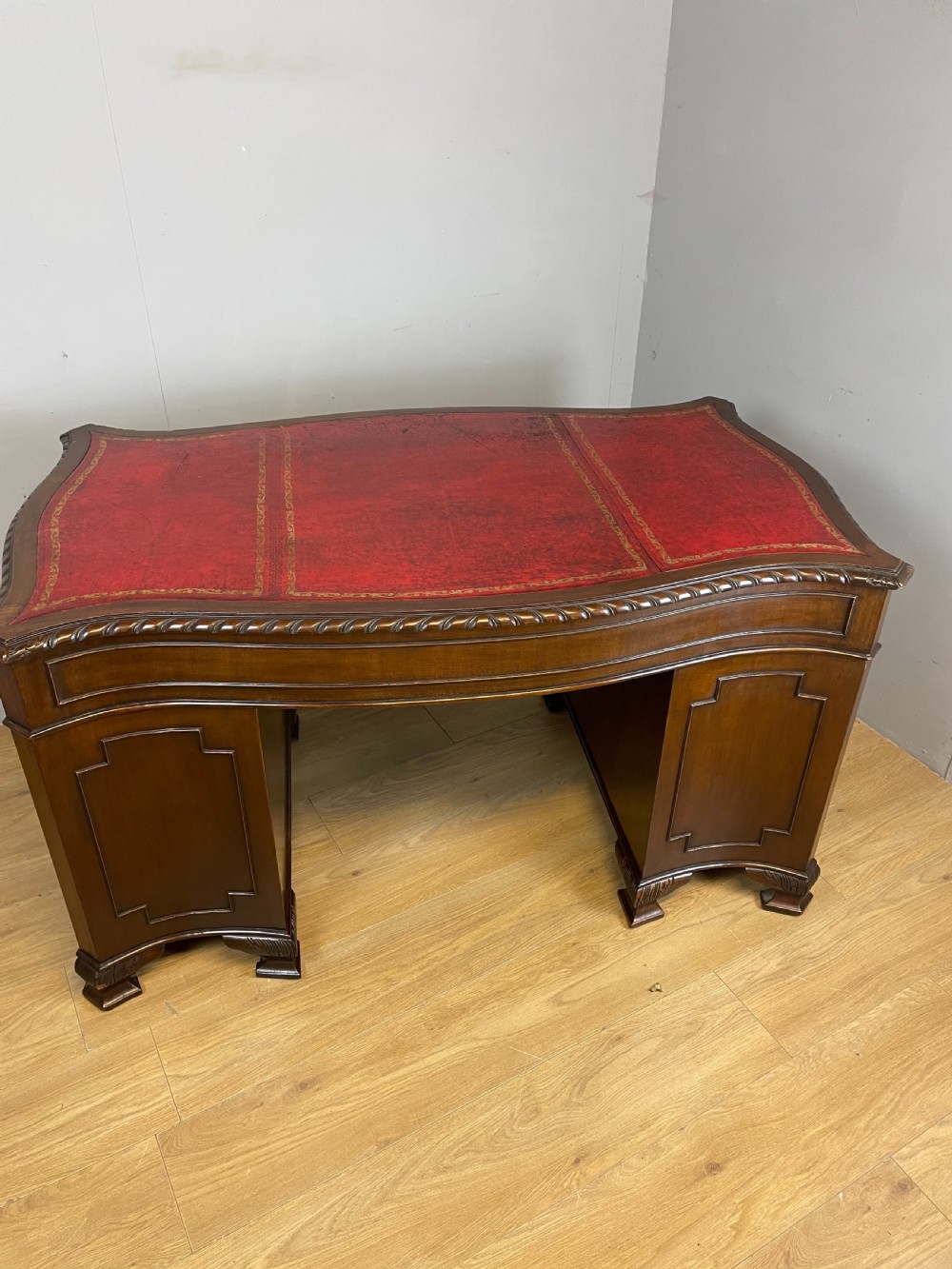 Serpentine sided Chippendale style mahogany desk with inset leather top View XIV