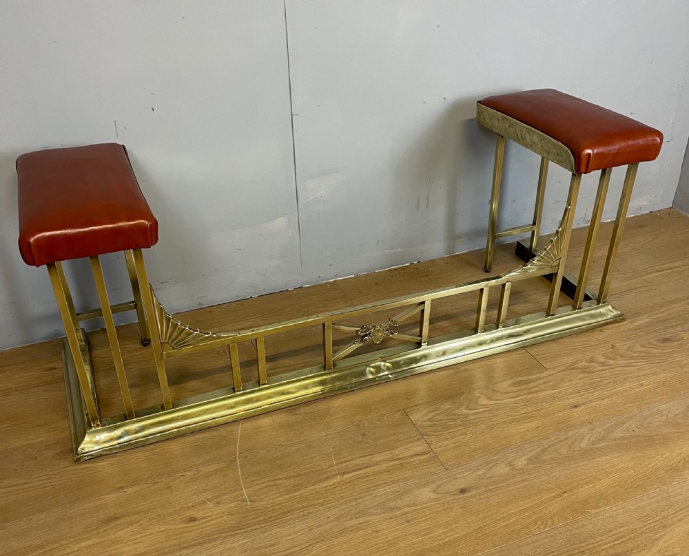 Edwardian brass and leather club fender