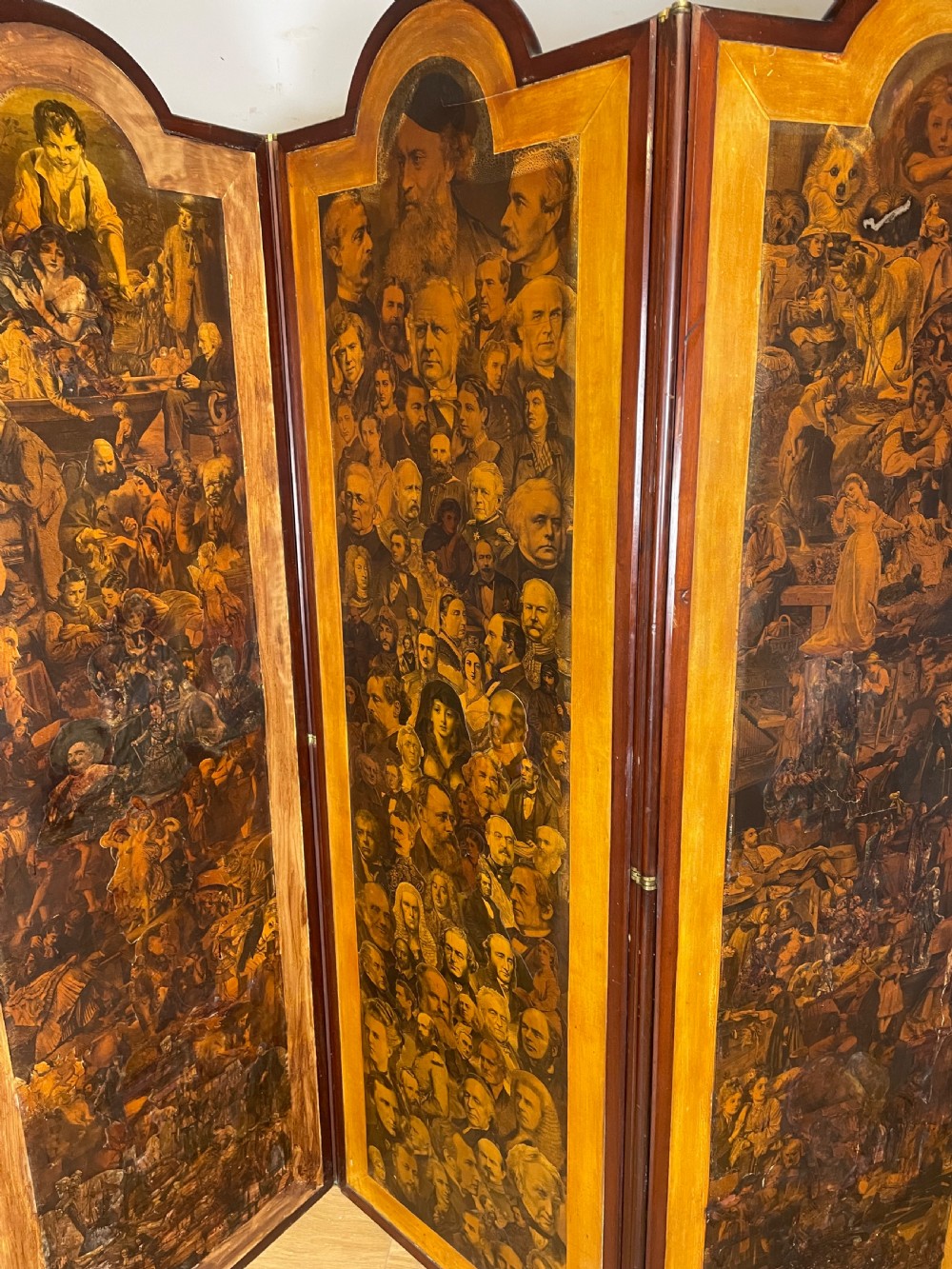 A three-panel wooden folding screen featuring dense Victorian decoupage artwork made of black and white engravings under a clear varnish finish. View III