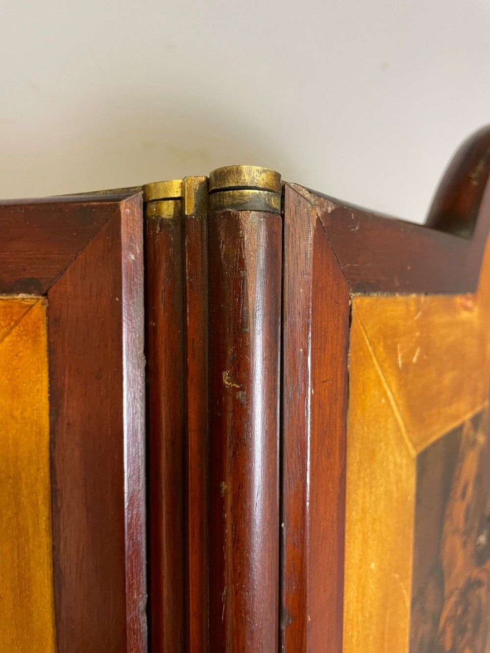 A three-panel wooden folding screen featuring dense Victorian decoupage artwork made of black and white engravings under a clear varnish finish. View V