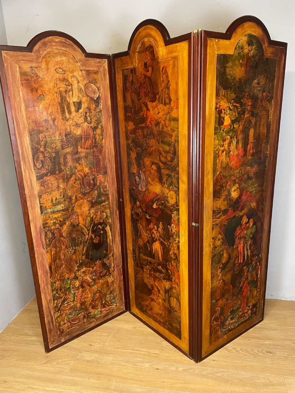 A three-panel wooden folding screen featuring dense Victorian decoupage artwork made of black and white engravings under a clear varnish finish. View IX