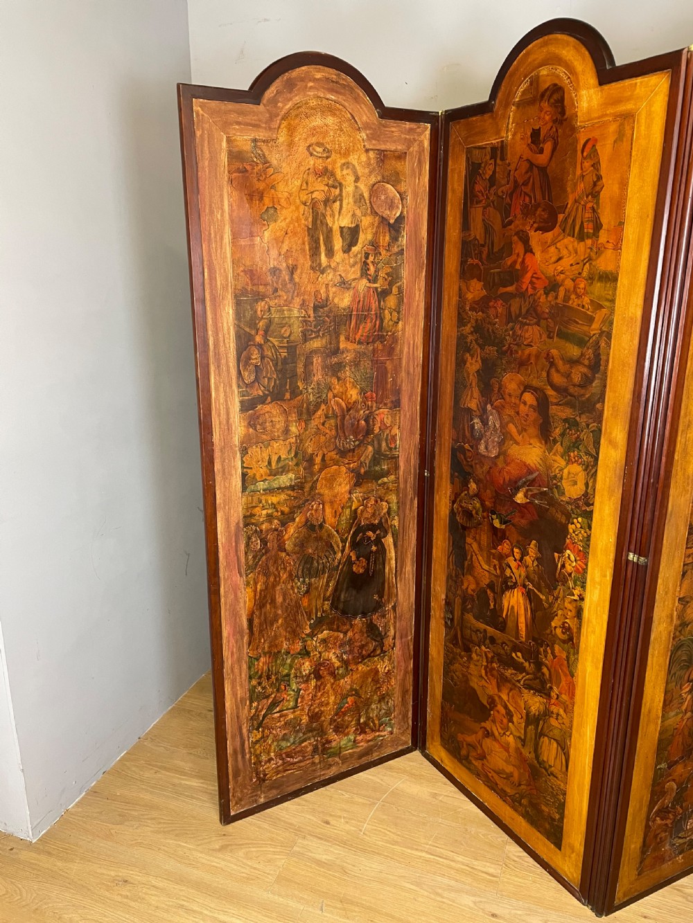 A three-panel wooden folding screen featuring dense Victorian decoupage artwork made of black and white engravings under a clear varnish finish. View X