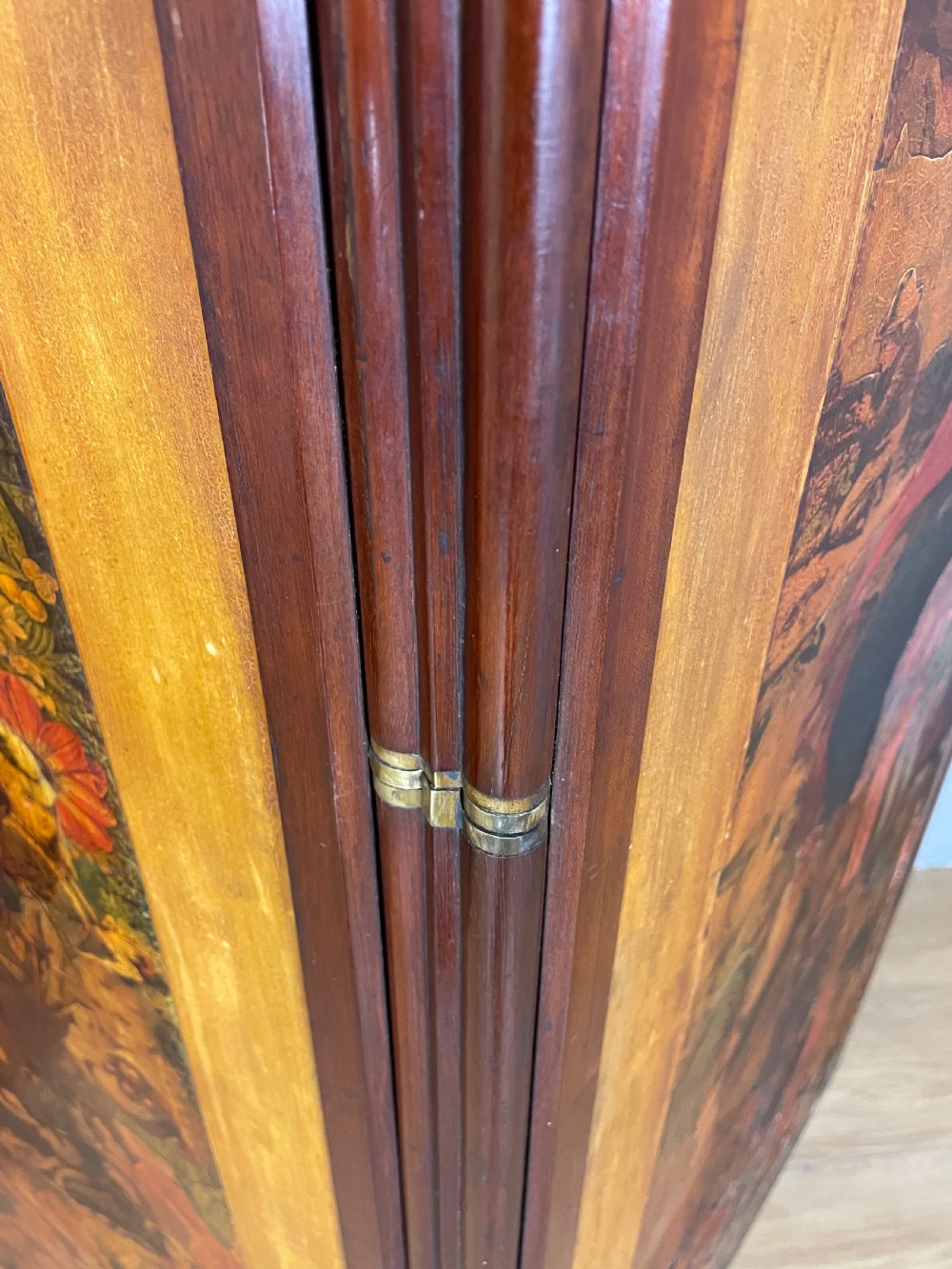 A three-panel wooden folding screen featuring dense Victorian decoupage artwork made of black and white engravings under a clear varnish finish. View XII
