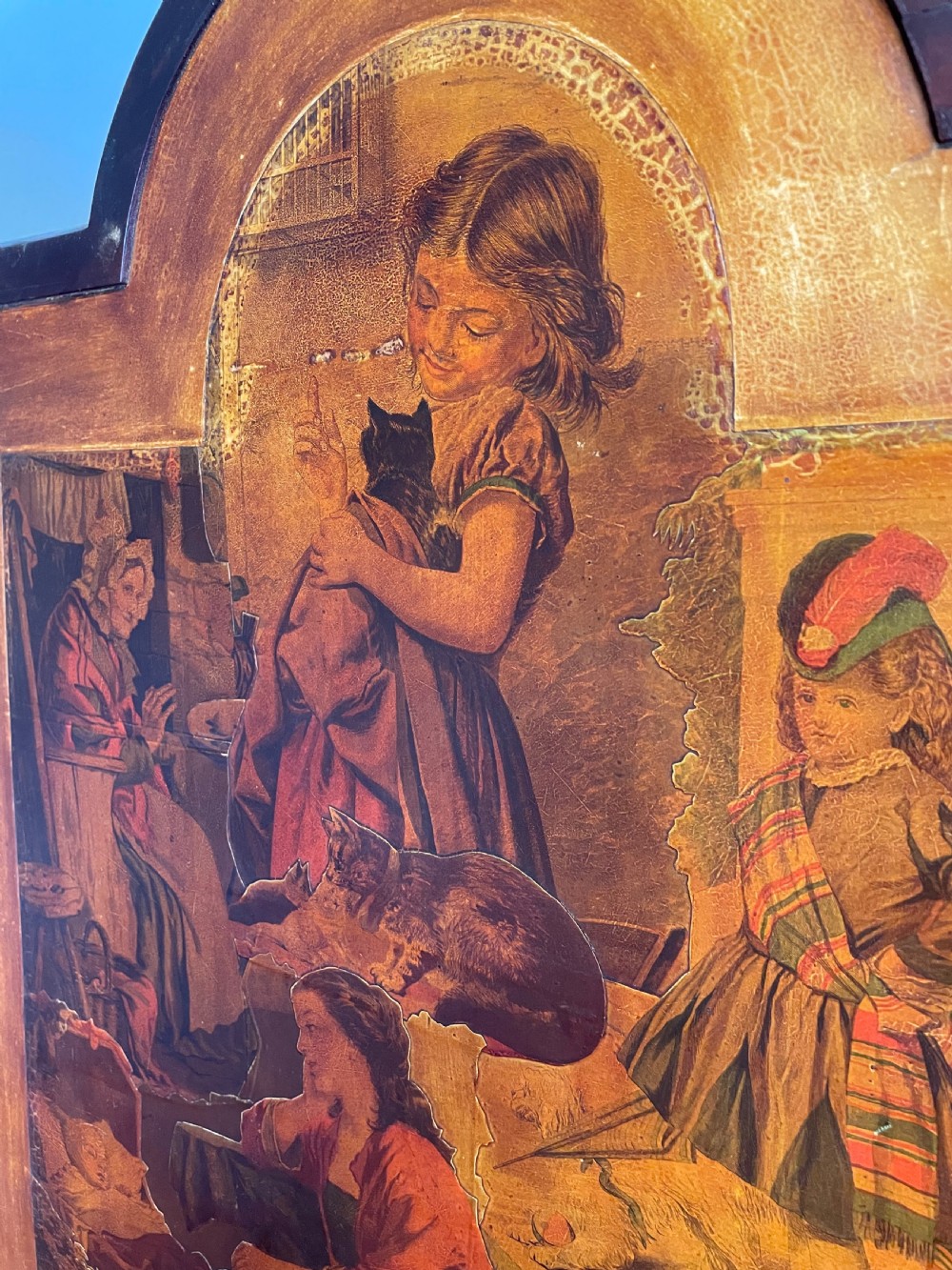 A three-panel wooden folding screen featuring dense Victorian decoupage artwork made of black and white engravings under a clear varnish finish. View XIII