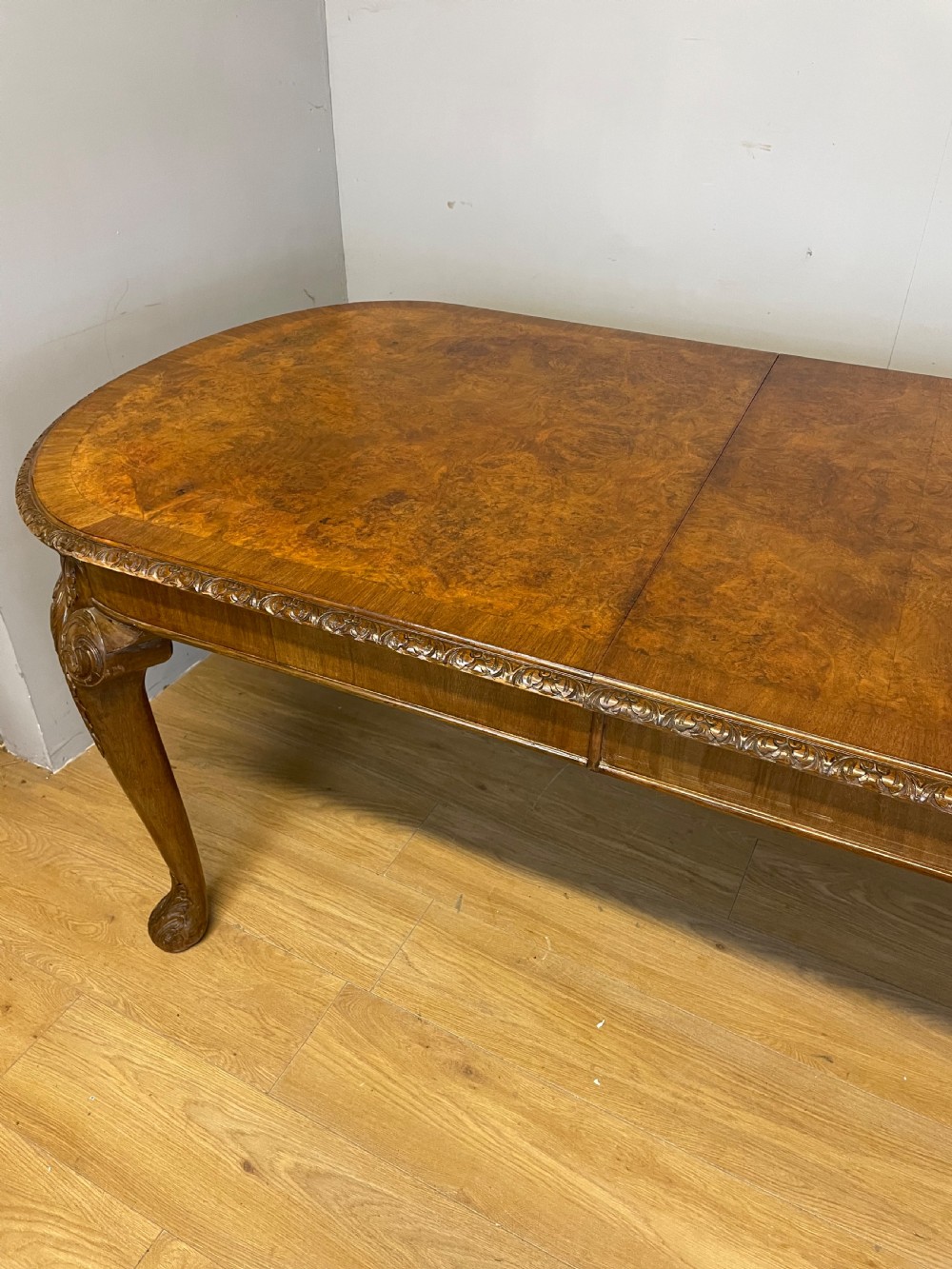 Burr walnut extending dining table on carved cabriole legs  View II
