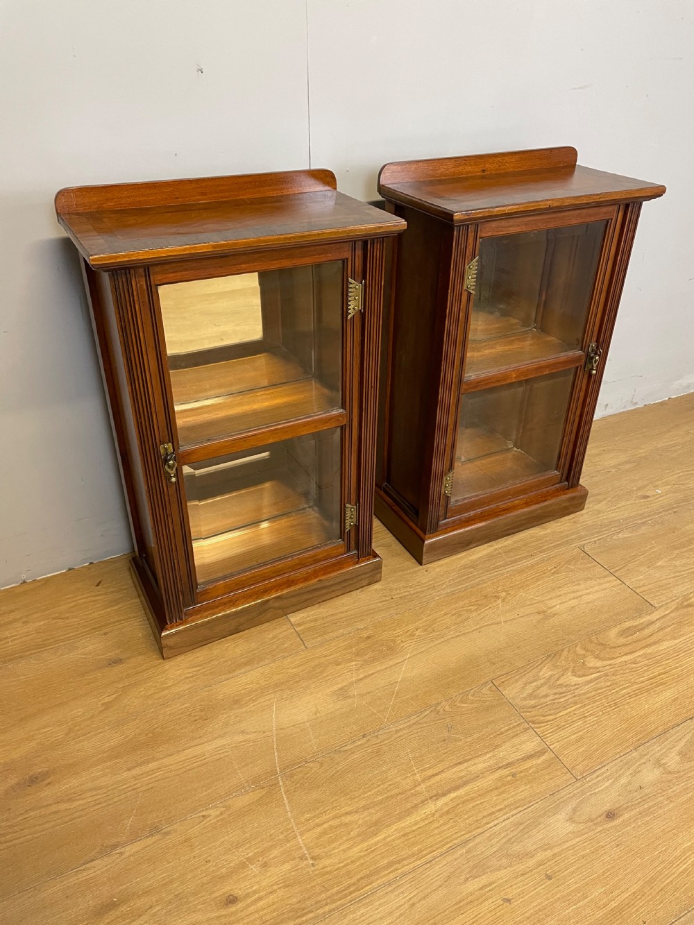 Small  pair of freestanding glazed walnut cabinets 
