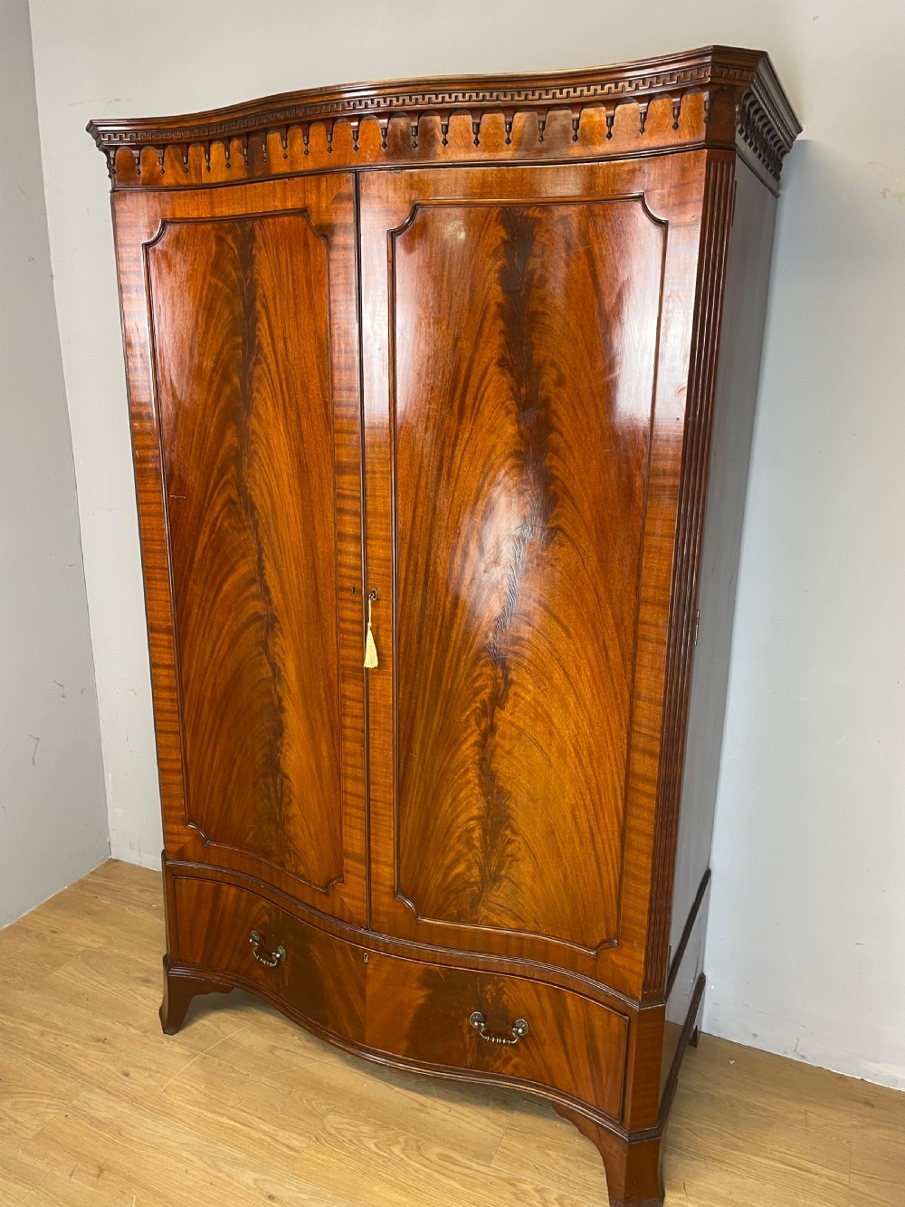 Edwardian flame mahogany serpentine fronted wardrobe 