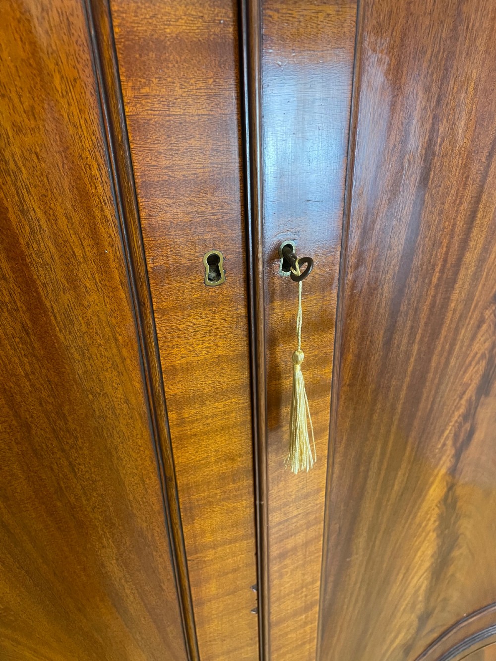 Edwardian flame mahogany serpentine fronted wardrobe  View V