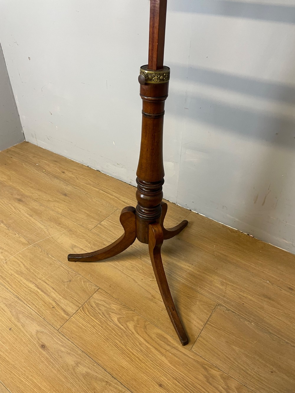 A 19th-century mahogany duet music stand featuring a double-sided adjustable reading frame on a turned column with brass fittings and tripod base. View III