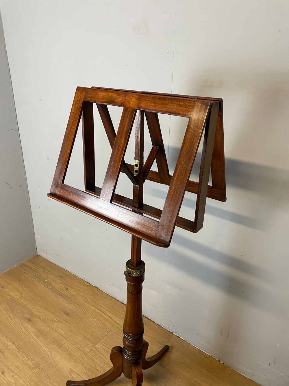 A 19th-century mahogany duet music stand featuring a double-sided adjustable reading frame on a turned column with brass fittings and tripod base. View IV
