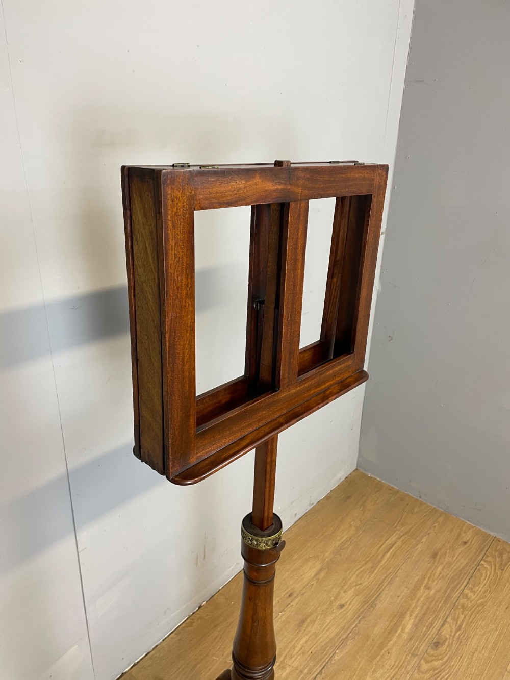 A 19th-century mahogany duet music stand featuring a double-sided adjustable reading frame on a turned column with brass fittings and tripod base. View V