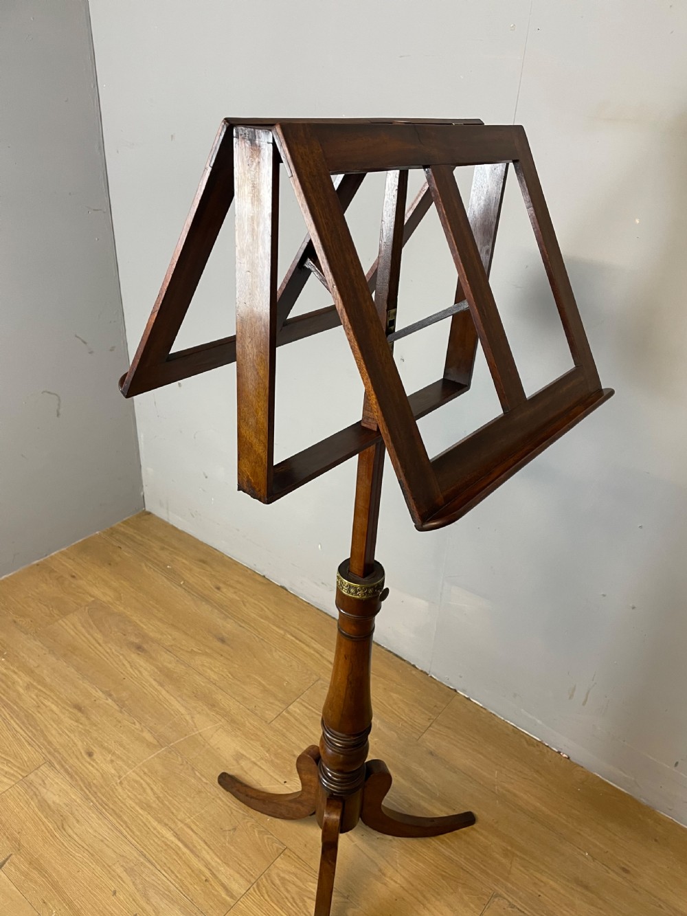 A 19th-century mahogany duet music stand featuring a double-sided adjustable reading frame on a turned column with brass fittings and tripod base. View VII