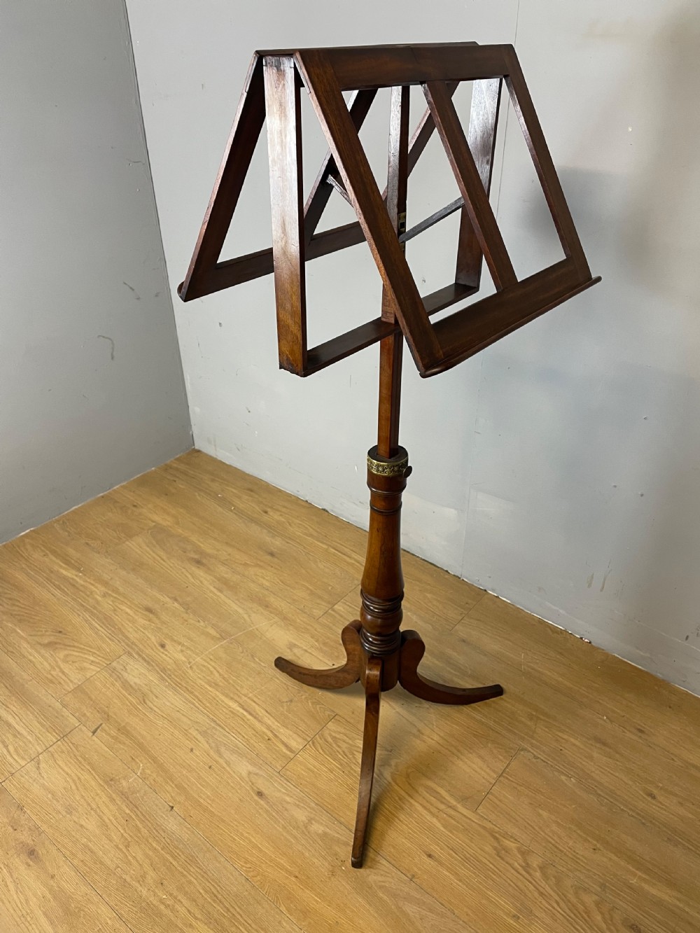 A 19th-century mahogany duet music stand featuring a double-sided adjustable reading frame on a turned column with brass fittings and tripod base. View IX