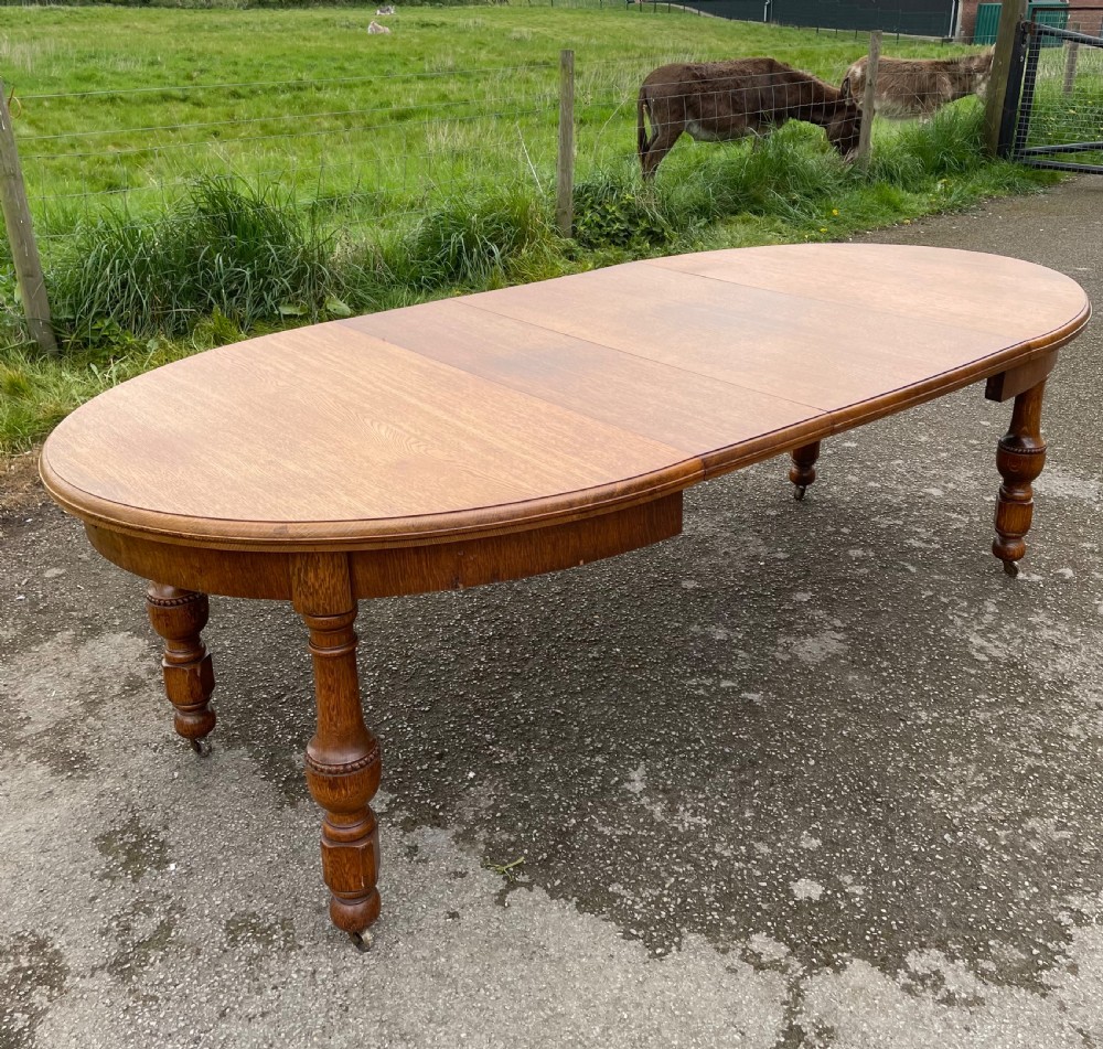 Large Arts and crafts golden oak wind out dining table  View II