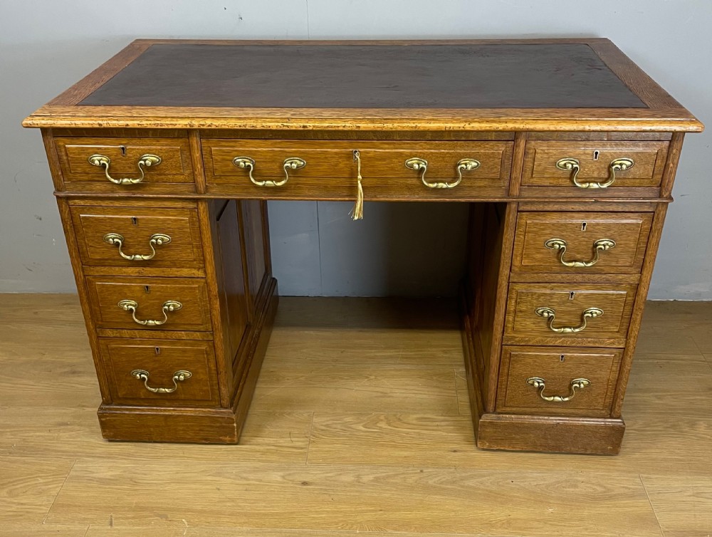 Edwardian solid oak twin pedestal desk with inset leather top 