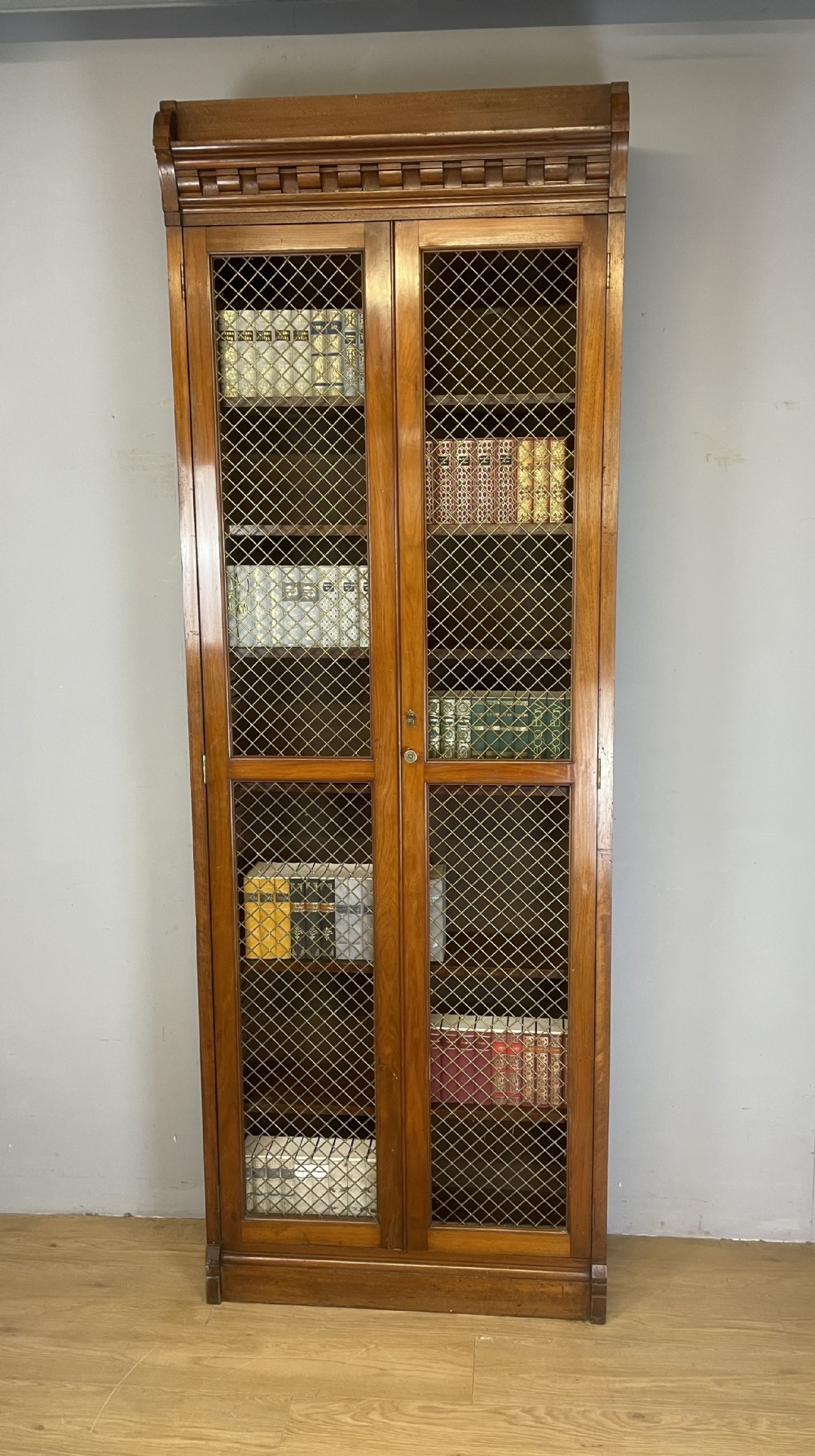 C19TH walnut two door country house bookcase with brass grilles
