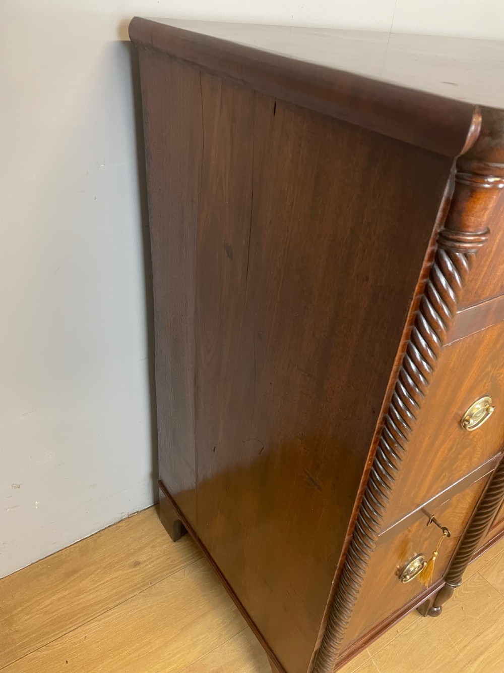 A Regency flame mahogany sideboard featuring rope-twist corner columns, multiple drawers with brass ring handles, and central cupboard doors. View VIII