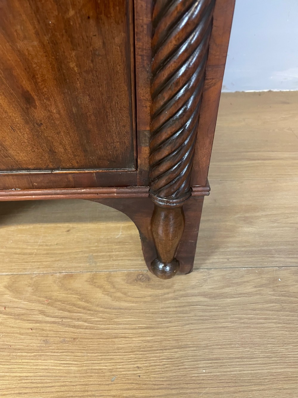 A Regency flame mahogany sideboard featuring rope-twist corner columns, multiple drawers with brass ring handles, and central cupboard doors. View XIII