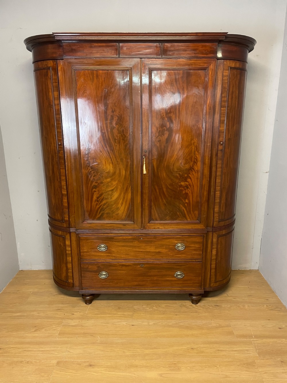 C19TH country house flame mahogany bow fronted and breakfront wardrobe 