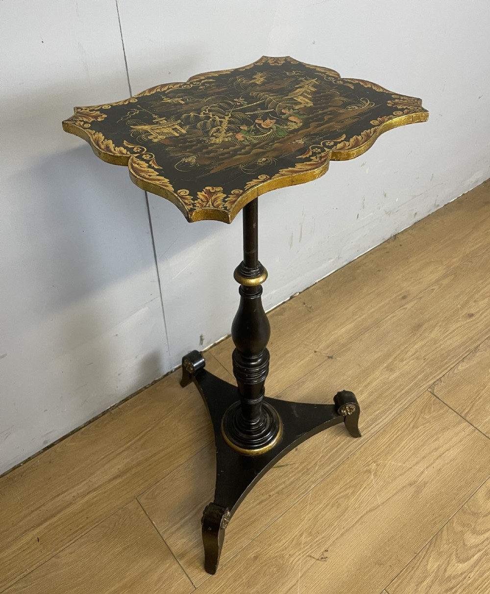A nineteenth-century Chinoiserie wine table featuring a scalloped black lacquered top with gilded oriental landscape decoration, supported by a turned ebonised column on a tripartite base. View III