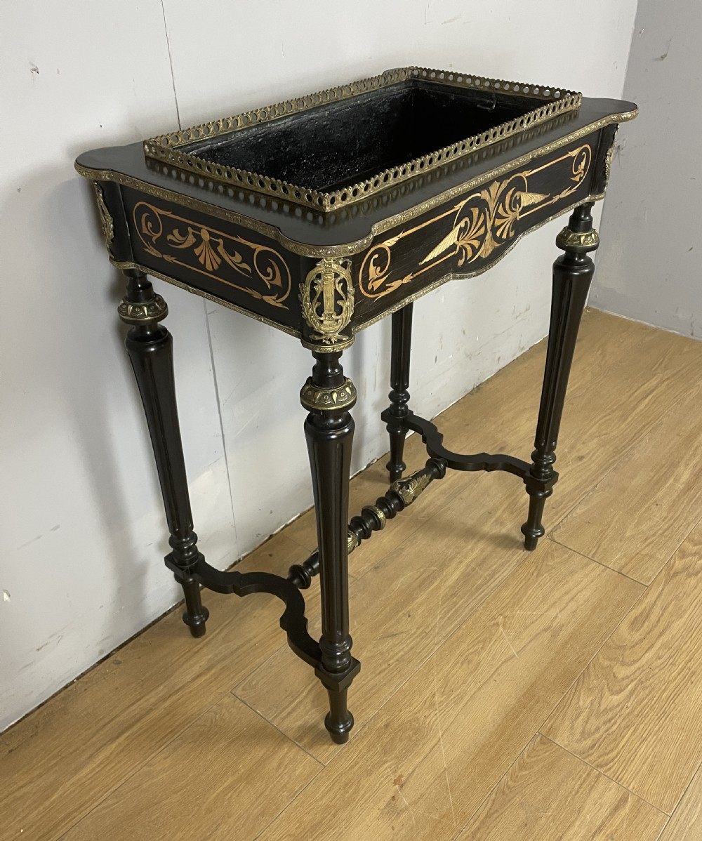 A 19th-century ebonised rectangular jardiniere table featuring intricate marquetry inlay, gilt-bronze mounts, turned legs, and a pierced brass gallery. View VI