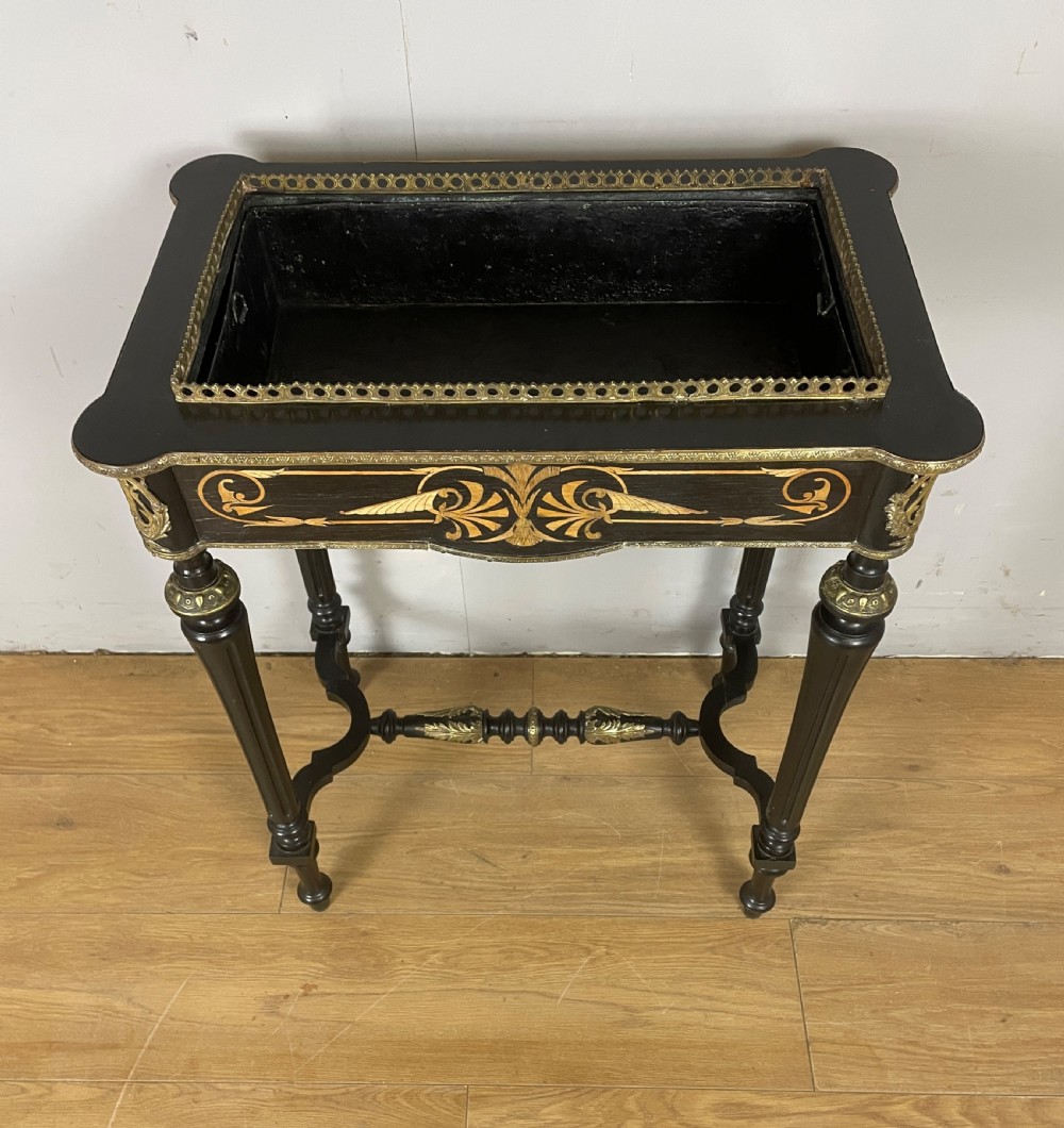 A 19th-century ebonised rectangular jardiniere table featuring intricate marquetry inlay, gilt-bronze mounts, turned legs, and a pierced brass gallery. View VII