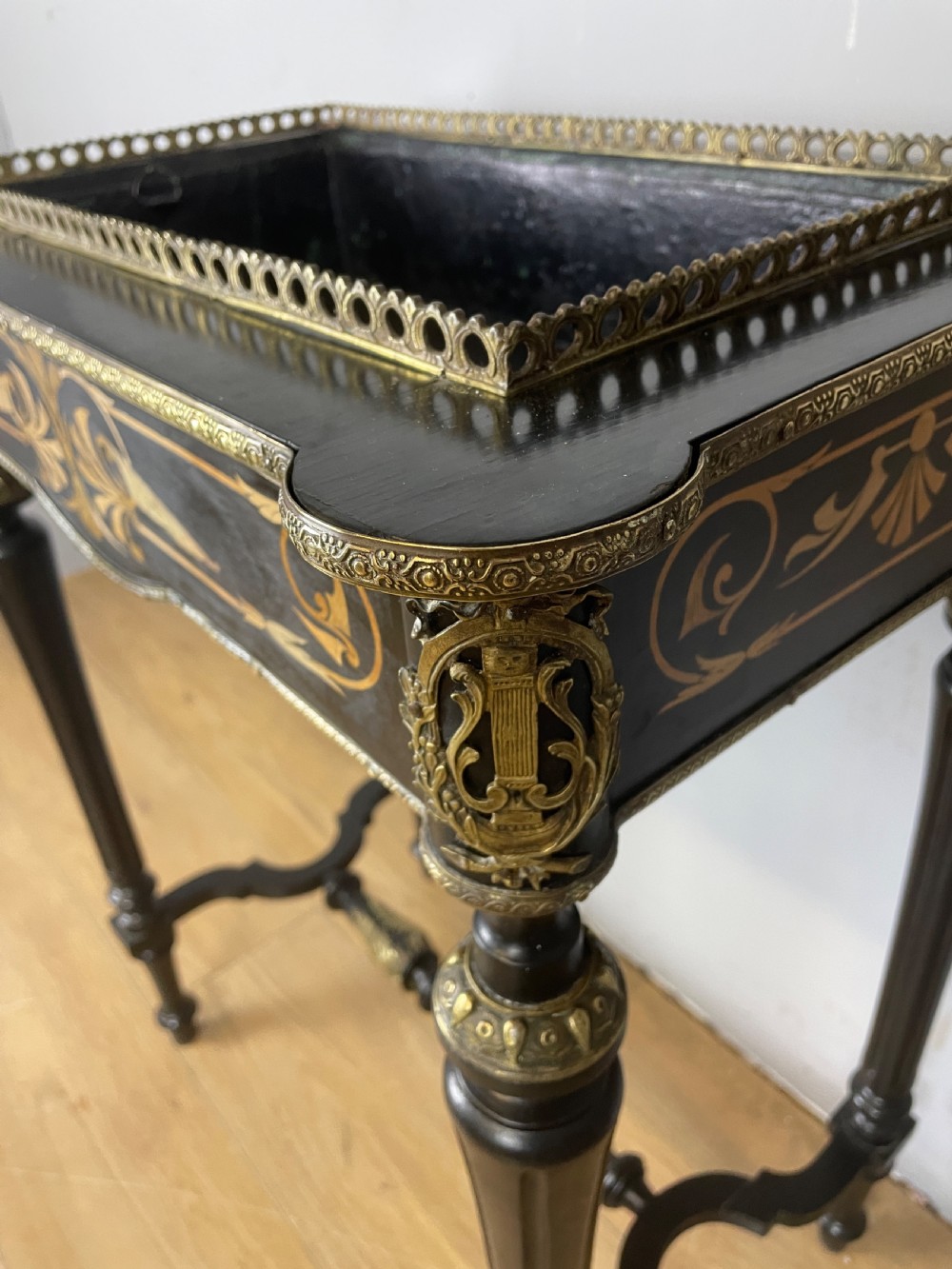 A 19th-century ebonised rectangular jardiniere table featuring intricate marquetry inlay, gilt-bronze mounts, turned legs, and a pierced brass gallery. View VIII