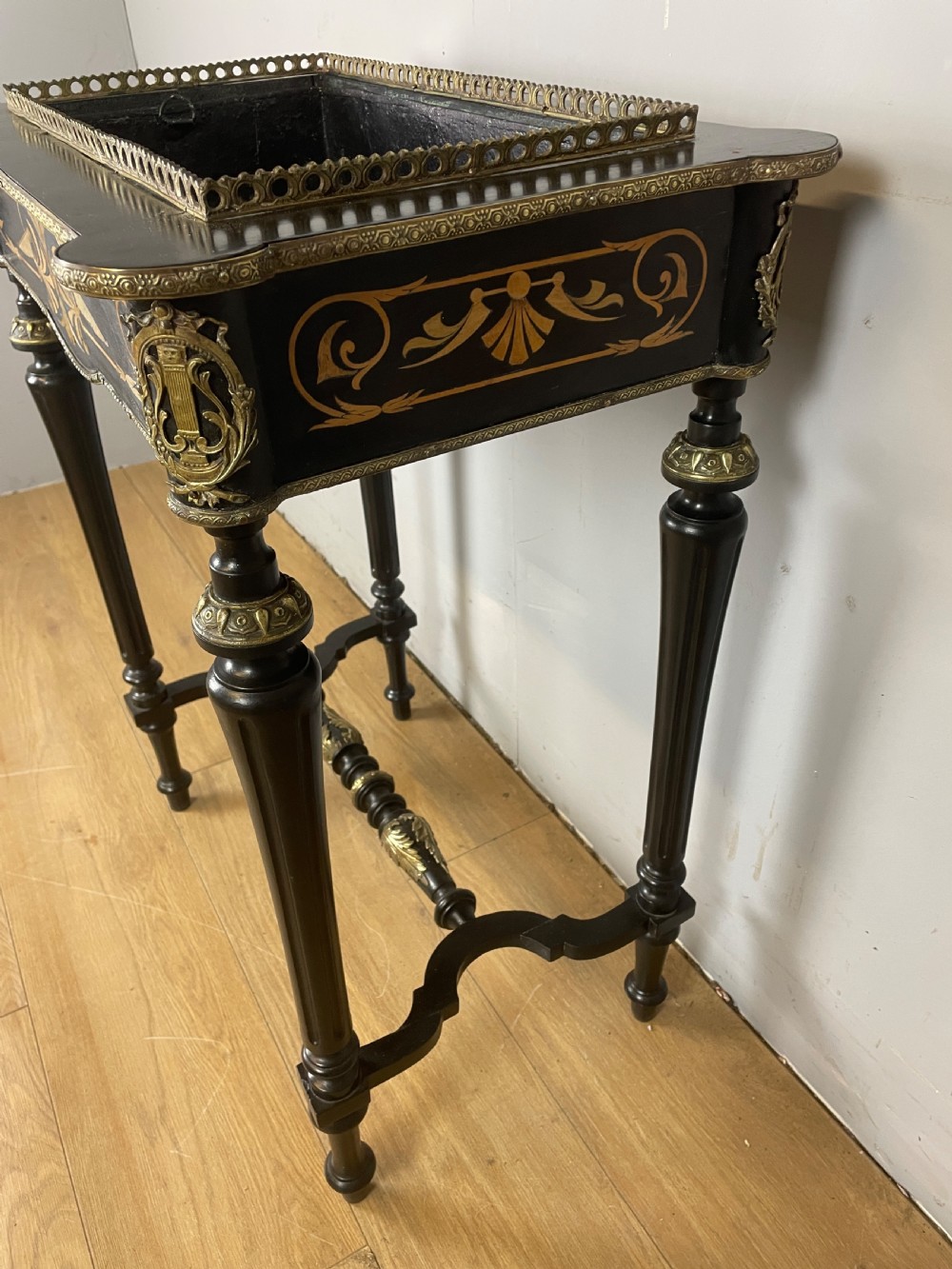 A 19th-century ebonised rectangular jardiniere table featuring intricate marquetry inlay, gilt-bronze mounts, turned legs, and a pierced brass gallery. View XII