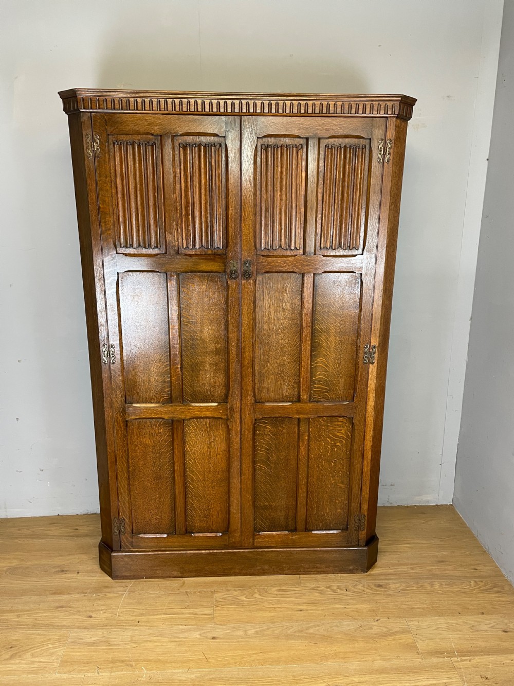 Early C20th linen fold oak hall cupboard 