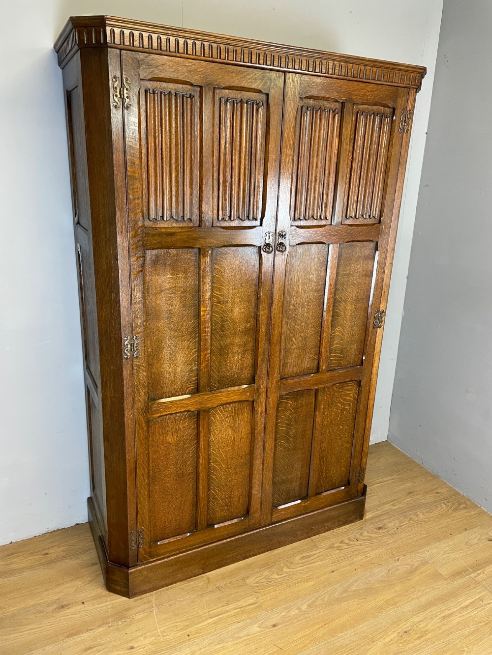 Early C20th linen fold oak hall cupboard  View II