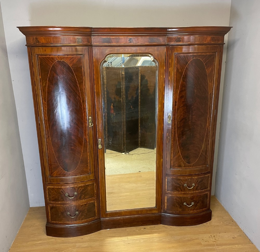 C19TH flame mahogany inlaid triple bow front wardrobe 
