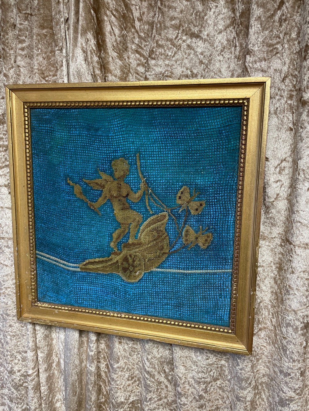 A pair of gilt-framed 19th-century needlework pictures featuring classical figures stitched in gold thread against a blue backdrop. View II