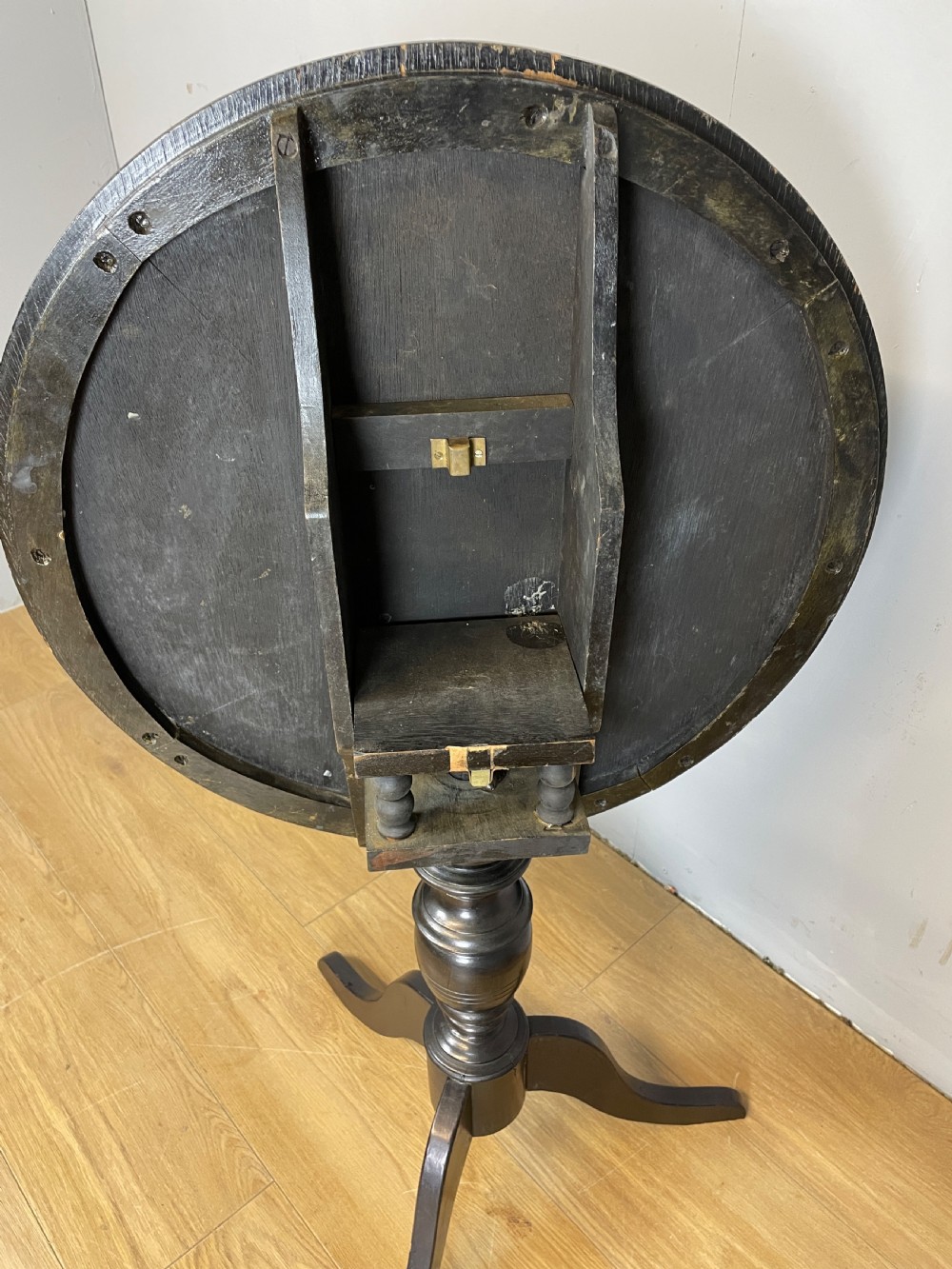 An Edwardian black lacquered circular tripod table decorated with mother-of-pearl figurative inlays and gilt floral borders. View VII