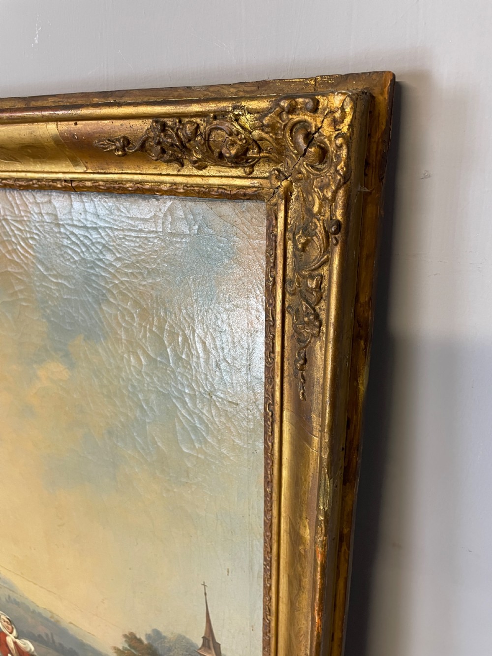 A tall 19th-century gilt-framed pier mirror featuring an upper integral landscape oil painting above a rectangular reflective mirror panel. View II