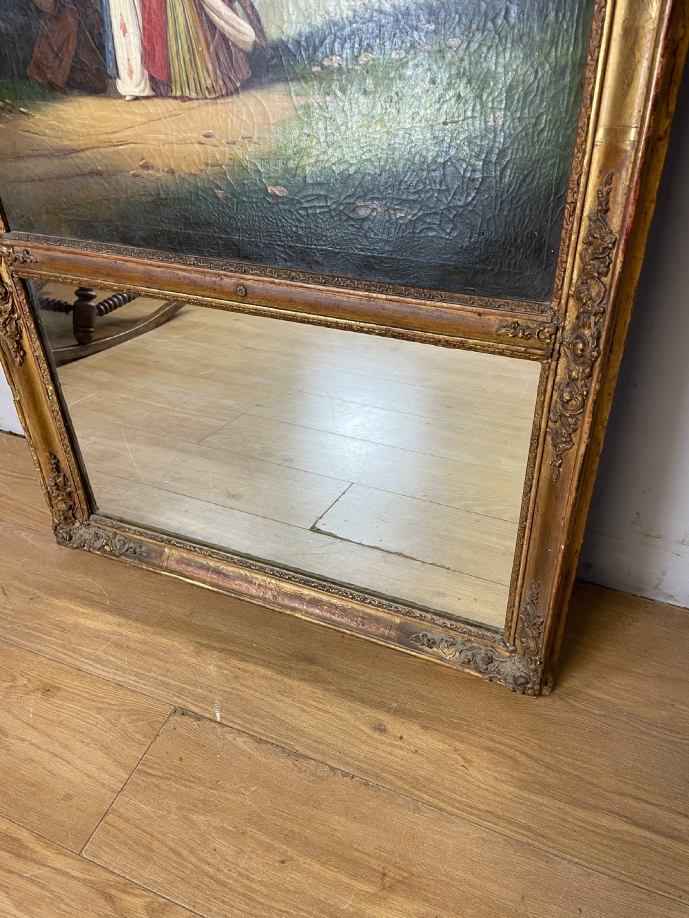 A tall 19th-century gilt-framed pier mirror featuring an upper integral landscape oil painting above a rectangular reflective mirror panel. View III