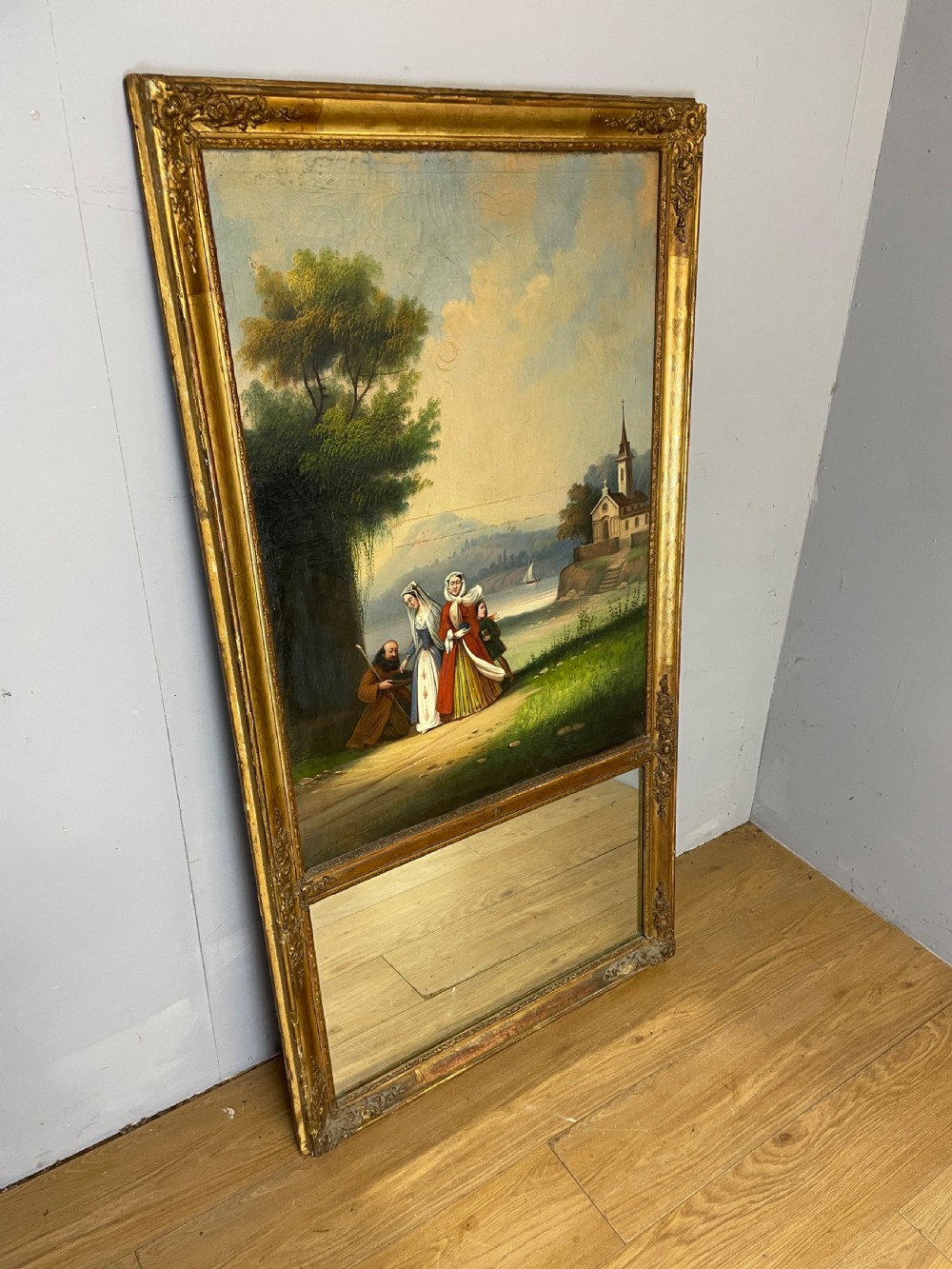 A tall 19th-century gilt-framed pier mirror featuring an upper integral landscape oil painting above a rectangular reflective mirror panel. View VI