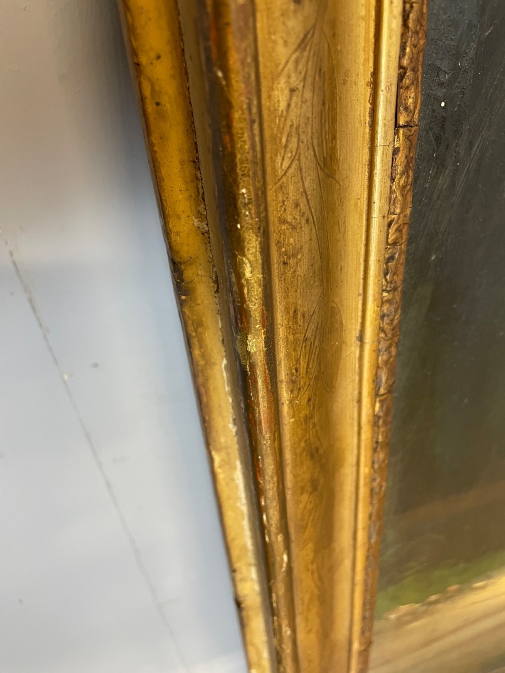 A tall 19th-century gilt-framed pier mirror featuring an upper integral landscape oil painting above a rectangular reflective mirror panel. View VII