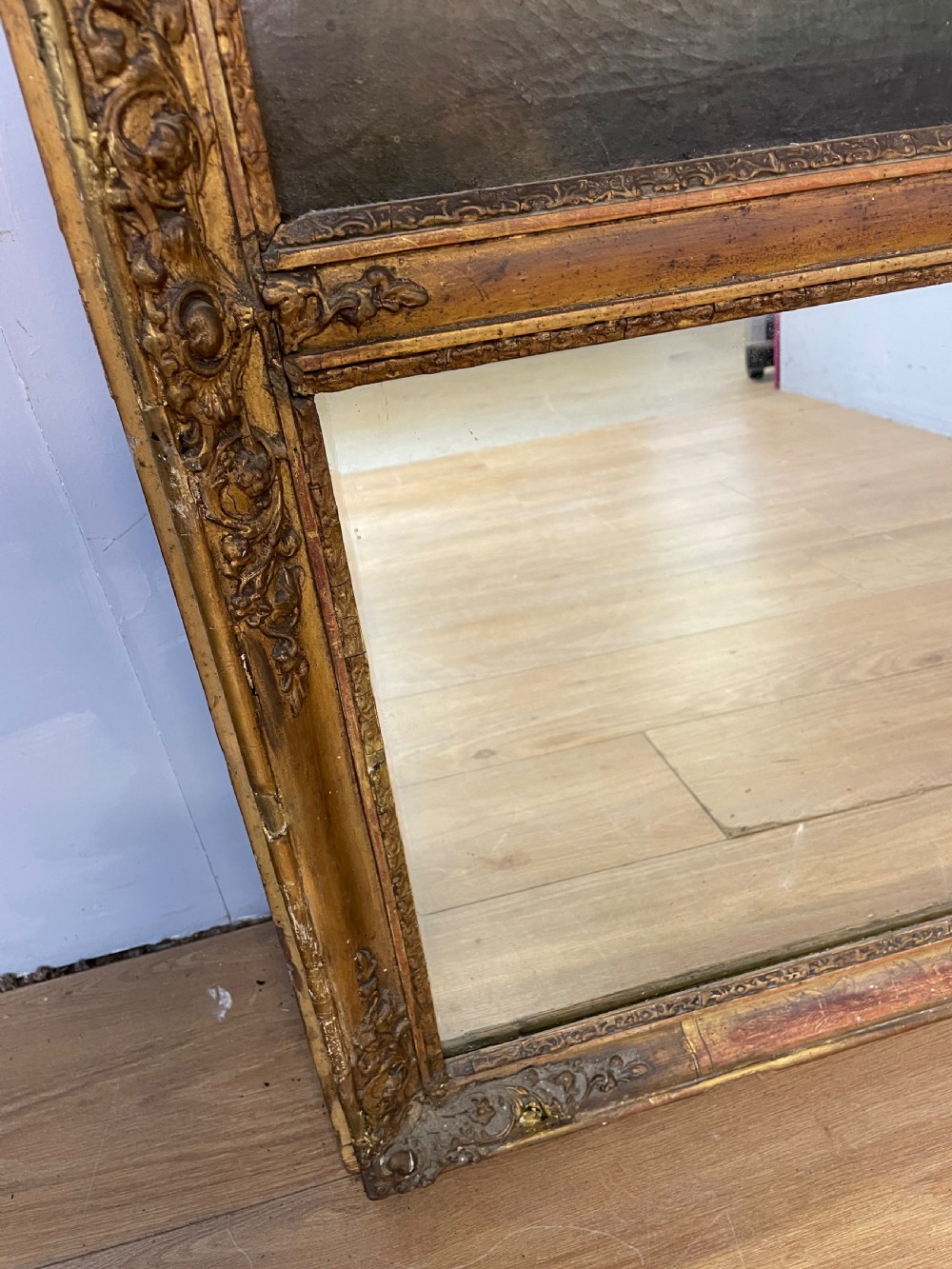A tall 19th-century gilt-framed pier mirror featuring an upper integral landscape oil painting above a rectangular reflective mirror panel. View VIII
