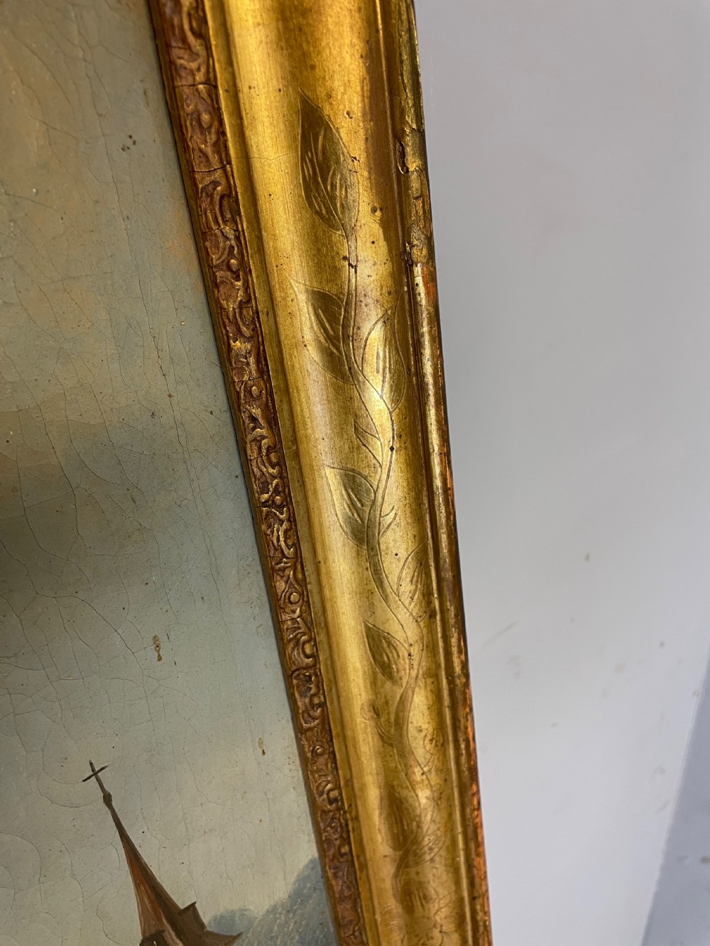 A tall 19th-century gilt-framed pier mirror featuring an upper integral landscape oil painting above a rectangular reflective mirror panel. View IX