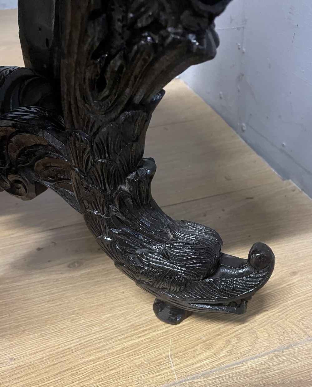A dark circular carved hardwood stand with pierced foliate aprons and heavy curved legs with detailed carved feet. View VIII