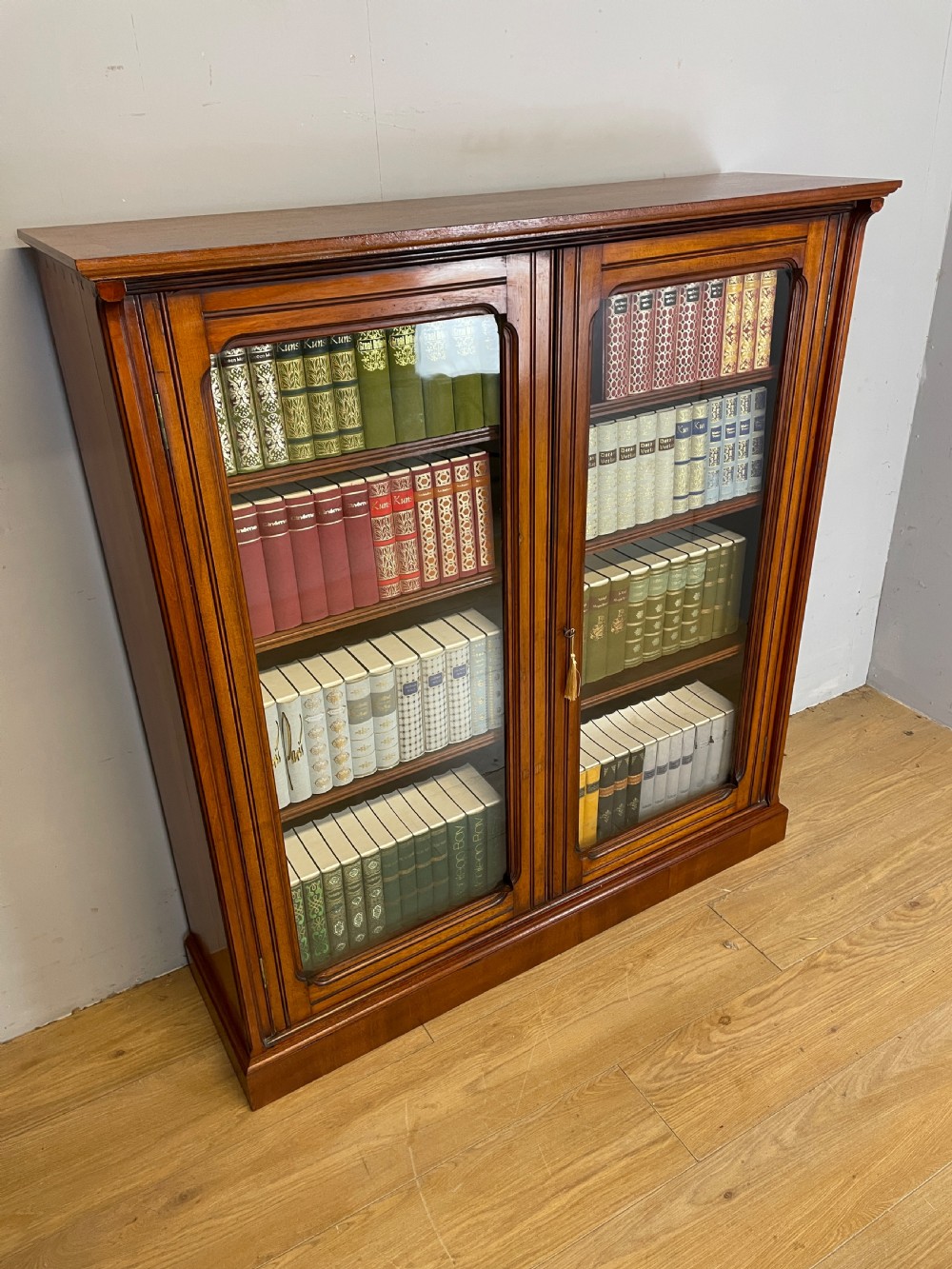 Arts and Crafts walnut freestanding glazed bookcase