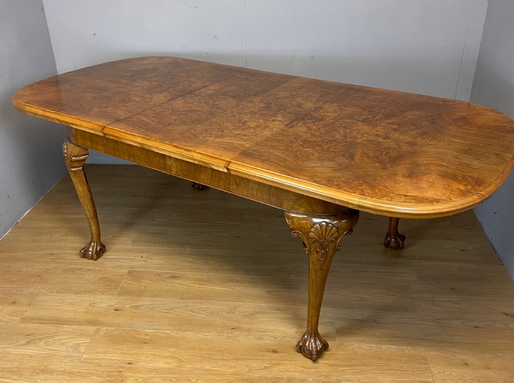 Burr walnut extending Queen Anne style six seater dining table 